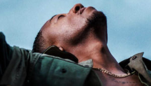 Christian rapper Lecrae's latest album shows him lifting arms up and looking toward the sky in a prayerlike pose.
