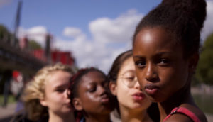 Four girls make pouting, selfie faces.