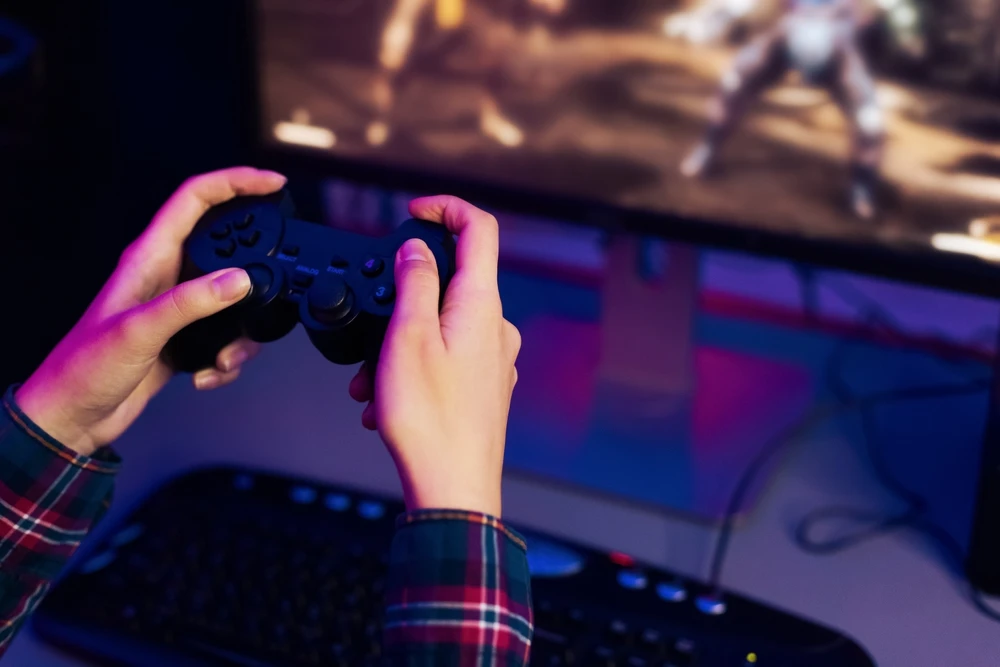 Close up of hands holding a video game controller